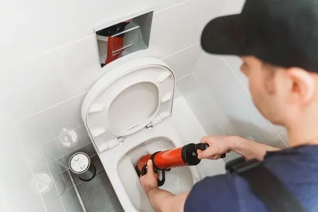 plumber-fixing-toilet-unclogging